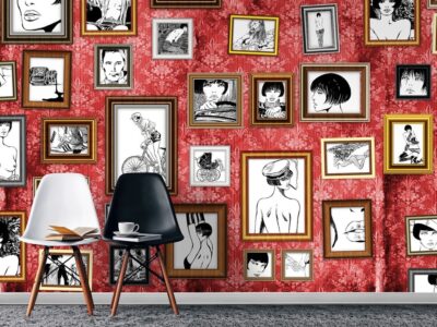 A vibrant room with red patterned wallpaper adorned with an eclectic collection of framed black-and-white sketches, accompanied by a modern table and chairs set.
