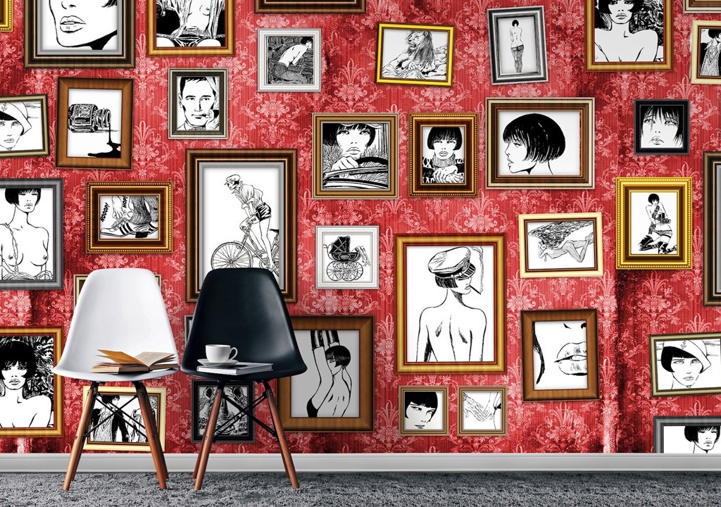 A vibrant room with red patterned wallpaper adorned with an eclectic collection of framed black-and-white sketches, accompanied by a modern table and chairs set.