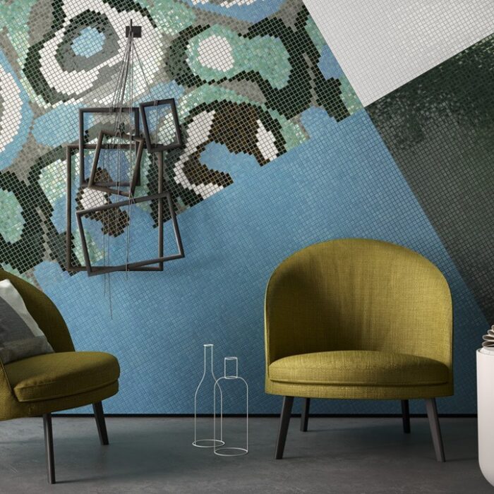 Contemporary living space with abstract wall art, featuring two olive green armchairs, geometric shelving, and chic lighting, creating a modern and stylish interior.